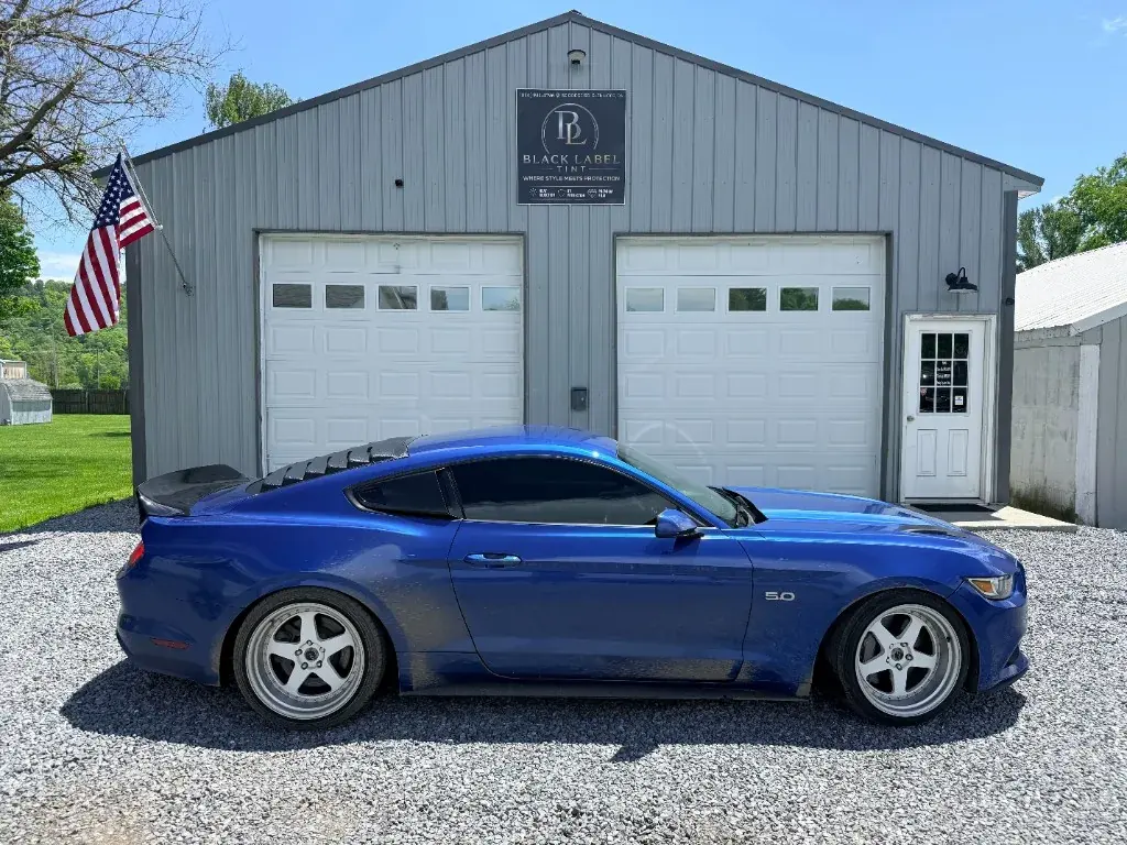 Blue Mustang after a detail outside the shop