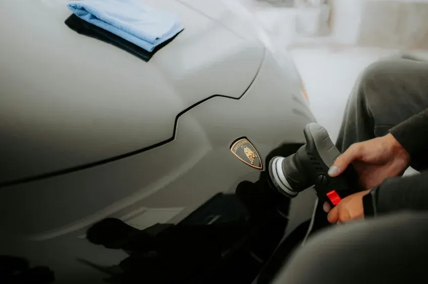 Detailer machine polishing a Lamborghini during paint correction