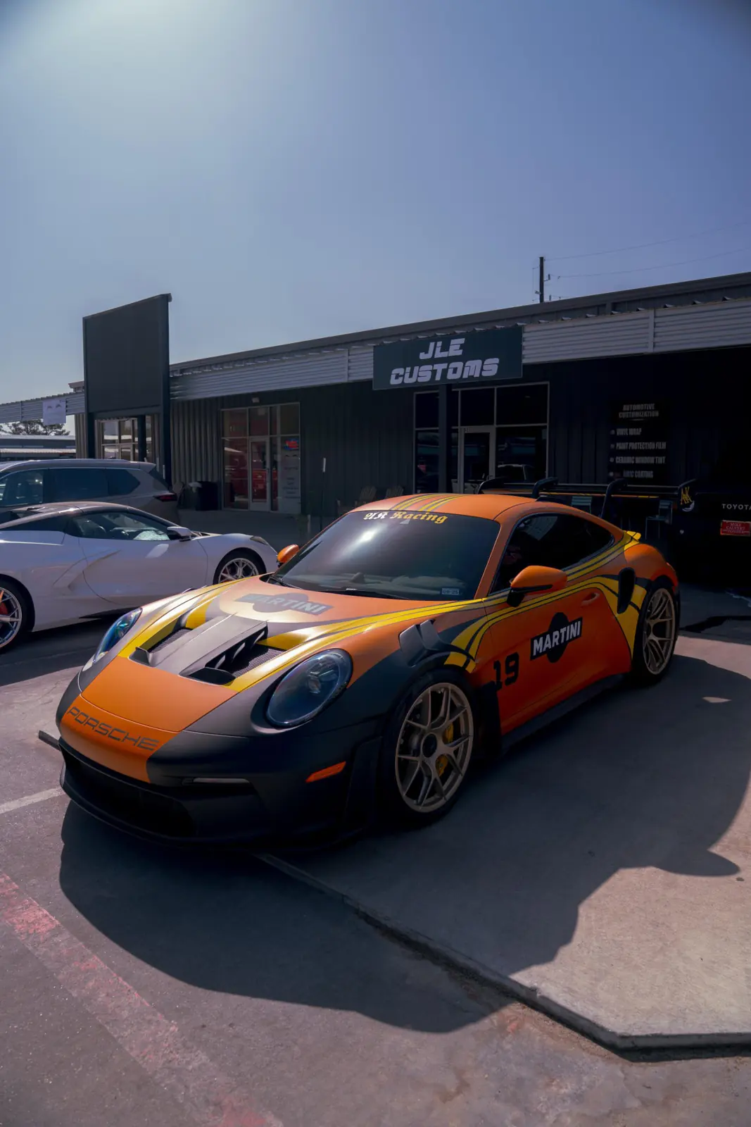 Porsche outside the JLE Customs storefront